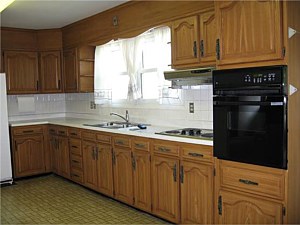 BEFORE: Stripped floor to ceiling, with island added and window changed